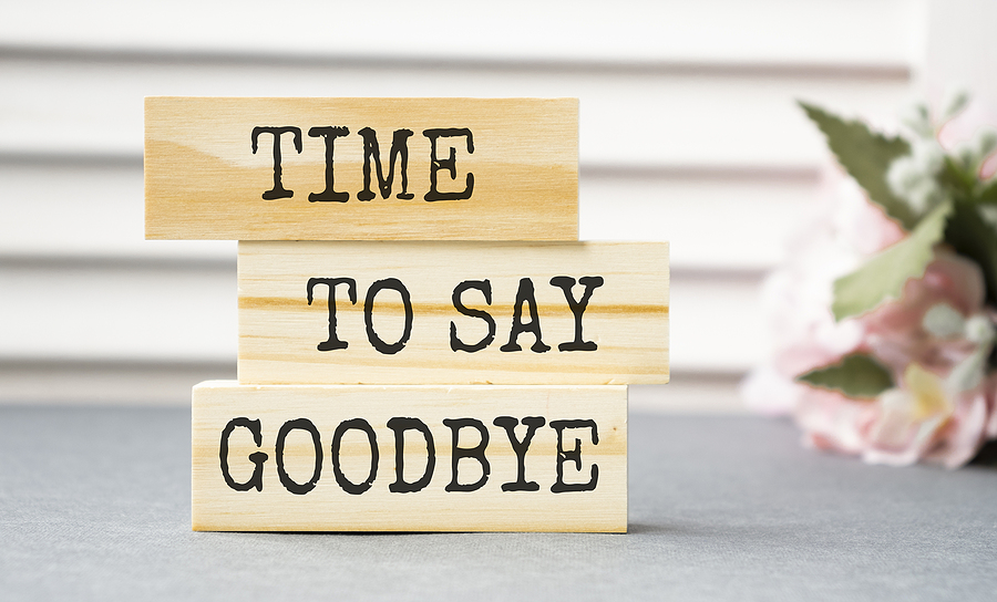 Wooden blocks with the words "Time to say goodbye" etched on them.