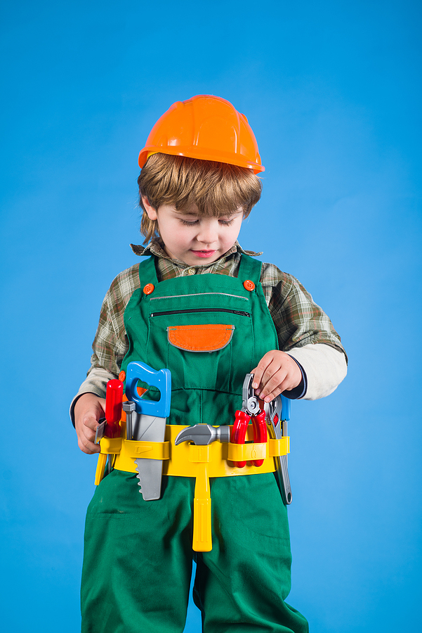 Child with utility belt and toy tools