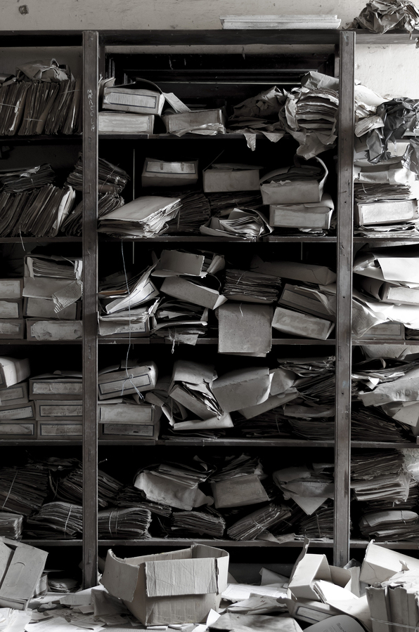 The broken state of archive in backup Ancient archive of dusted papers in a forgotten storage place.